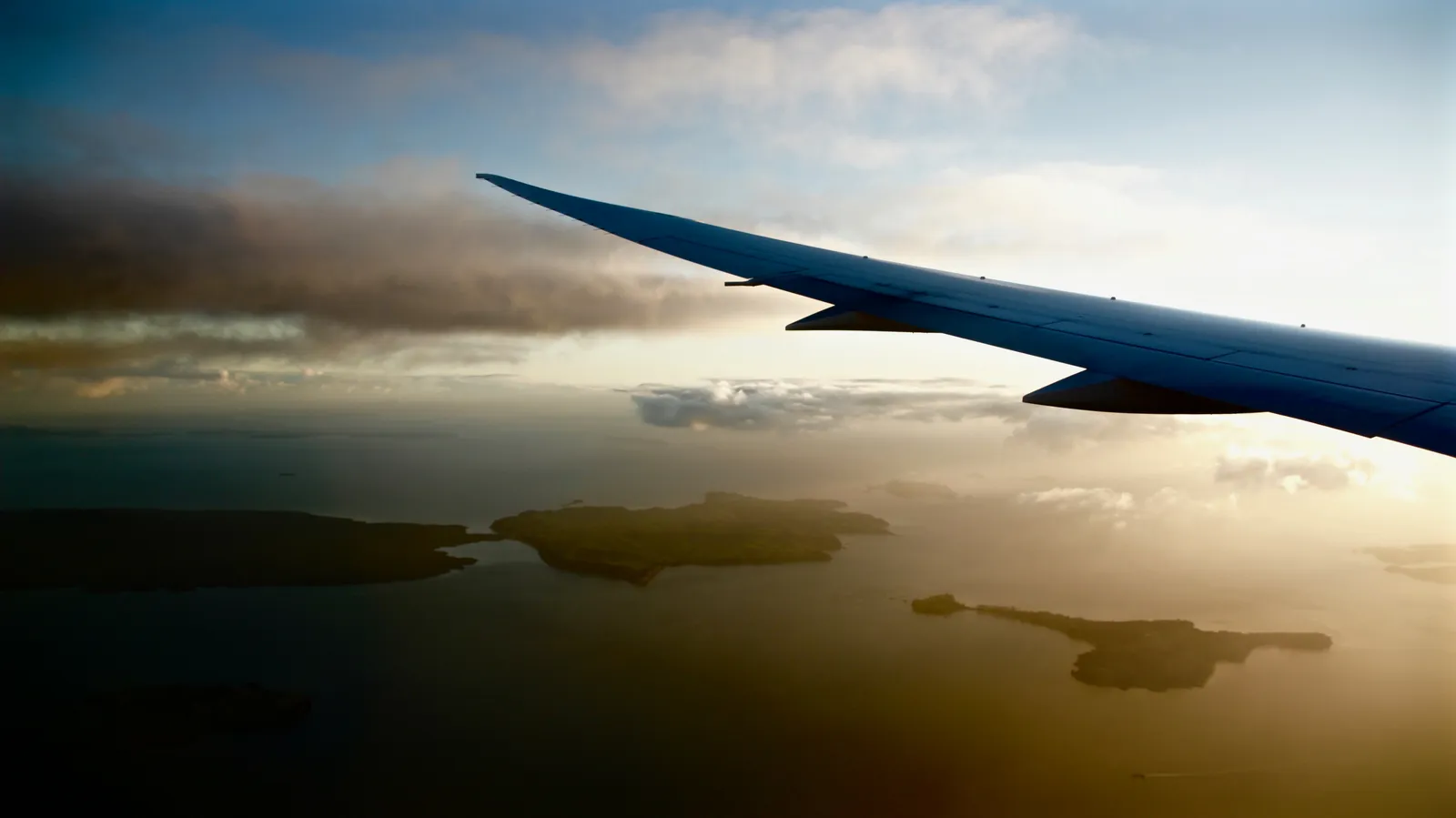 Travel to Raja Ampat — In the air above green islands (Unsplash)